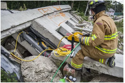 Firefighters lifting collapsed concrete at a collapse site